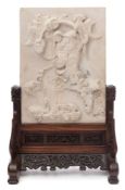 A Chinese stone table top screen: depicting the God of Wealth dancing with ribbon tied coins,