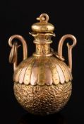 A two-colour gold globular bottle charm with detachable stopper:, 5.5gms gross weight.