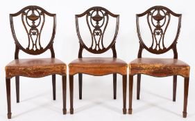 A set of six late 19th Century carved mahogany dining chairs in the Hepplewhite taste:,