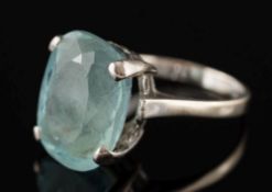 An 18ct white gold and oval aquamarine single-stone dress ring:,