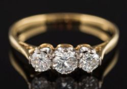 A gold and diamond three-stone ring: with graduated,