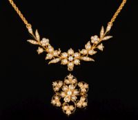 A Victorian gold and seed pearl necklace: of openwork foliate design in fitted case with a similar