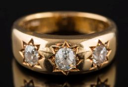 An 18ct gold and diamond three-stone 'gypsy' ring: star-set with graduated,
