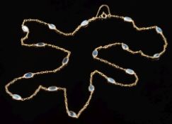 A gold and moonstone necklace: with seventeen oval moonstones each approximately 10mm long and in