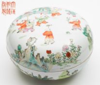 A Chinese famille rose bowl and cover: painted with children playing in a garden with a zig-zag