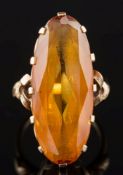 A gold and oval citrine single-stone ring: the citrine approximately 29mm long x 11.8mm wide x 6.