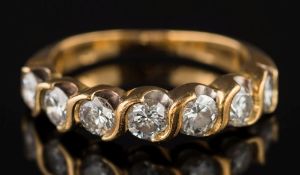 A diamond mounted seven-stone half-hoop ring: with circular brilliant-cut diamonds each