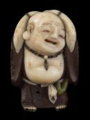 A Japanese carved and stained ivory and boxwood netsuke,