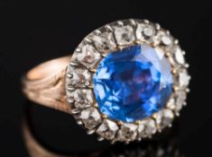 A Georgian foil backed sapphire and diamond cluster ring: the cushion-cut sapphire approximately 10.
