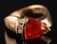 A modern fire opal and diamond four-stone ring: with triangular fire opal approximately 11mm wide,