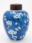 Two Chinese porcelain jars and covers: one of oviform painted in blue with prunus,