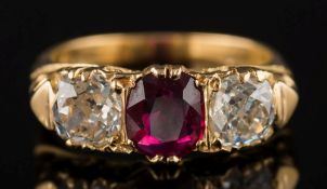 A ruby and diamond three-stone ring:, the central oval ruby approximately 7.5mm x 6.