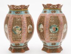 A pair of Chinese famille rose porcelain pierced lanterns and stands: of hexagonal barrel form,