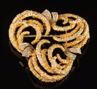 An 18ct gold and diamond mounted trefoil cluster brooch: of textured finish, 39mm wide, 14.