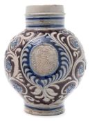 A large German Westerwald stoneware 'AR' jug: painted in blue and manganese and incised and applied