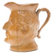 A Stephen Green, Lambeth brown stoneware 'Wellington' character jug: with scroll handle,