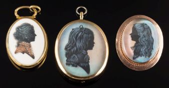 An oval silhouette portrait of a young girl, 36mm long, in a 9ct gold frame,