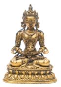 A Chinese gilt-bronze Buddha: in Dhyana Mudra pose supporting a lamp,