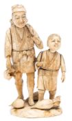 A Japanese carved ivory sectional okimono of peasant and son: collecting gourds,