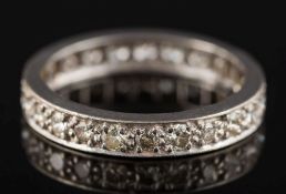 A diamond mounted eternity ring: pave-set with 24 circular,