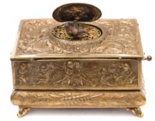 A late 19th/early 20th century brass automaton bird musical box: the top and sides with embossed