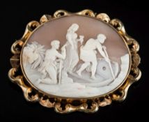 A large oval shell cameo brooch: the cameo depicting three classical figures boarding a small boat,