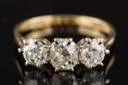 An 18ct gold and diamond three-stone ring: with graduated, old-cut diamonds approximately 0.51ct, 0.