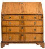 A walnut veneer and feather banded bureau:,