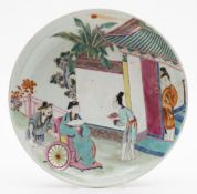 A Chinese porcelain shallow dish: decorated in a bright famille rose palette with a scholar in a