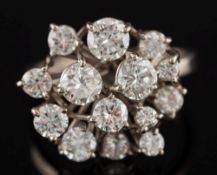 A diamond mounted round cluster ring: with an informal cluster of brilliant-cut diamonds estimated