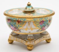 A Rockingham porcelain desk stand: of oval form set on four lion paw supports on a quadrilobed