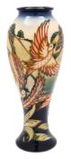 A Moorcroft pottery vase: of slender baluster form tubelined in the Lark Ascending pattern after