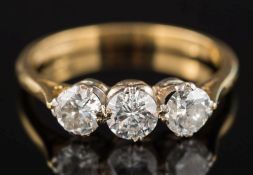 An 18ct gold and diamond three-stone ring: with circular, old-cut diamonds approximately 0.30ct, 0.