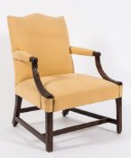 A George III carved mahogany library open armchair of Gainsborough type:,