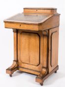 A Victorian satin birch Davenport:, with ebonised mouldings,