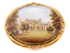 A 19th century gold-mounted English porcelain brooch: the porcelain possibly Rockingham and painted