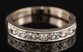 An 18ct white gold and diamond half-eternity ring:,