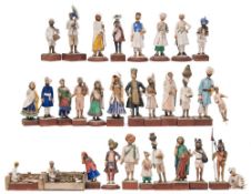 A collection of thirty Indian Raj plaster and terracotta educational figures: depicting various