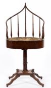 A Regency mahogany oval jardiniere stand:, with spindle turned and curved ogee superstructure,