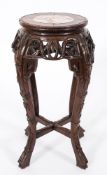 A Chinese carved hardwood circular jardiniere stand:,