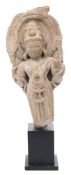 An Indian carved schist fragmentary figure: of a male deity wearing a beaded dhoti,