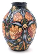 A Moorcroft pottery vase: of oviform tube lined in the Shepherds Clock pattern after the original