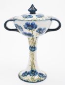 A Macintyre (Moorcroft) Florian Ware two handled vase and cover: the slender foot supporting the