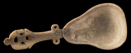 An Inuit reindeer horn spoon: the pear-shaped bowl with incised decoration of a reindeer,