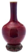 A Chinese flambe-glazed bottle vase: with globular body and cylindrical neck covered in a mottled