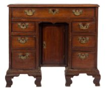 An 18th Century 'red walnut' and inlaid kneehole desk:, the top with a moulded edge,