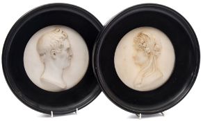 Joseph Gott [1786-1860] A pair of relief carved marble portrait medallions of Mr and Mrs Benjamin