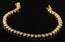 A diamond mounted line bracelet: with thirty-nine circular brilliant-cut diamonds each
