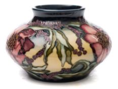 A Moorcroft pottery vase: of squat form tubelined in the Woodstock pattern after the original by