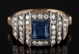 An Art Deco sapphire and diamond cluster ring: the central rectangular sapphire approximately 6mm